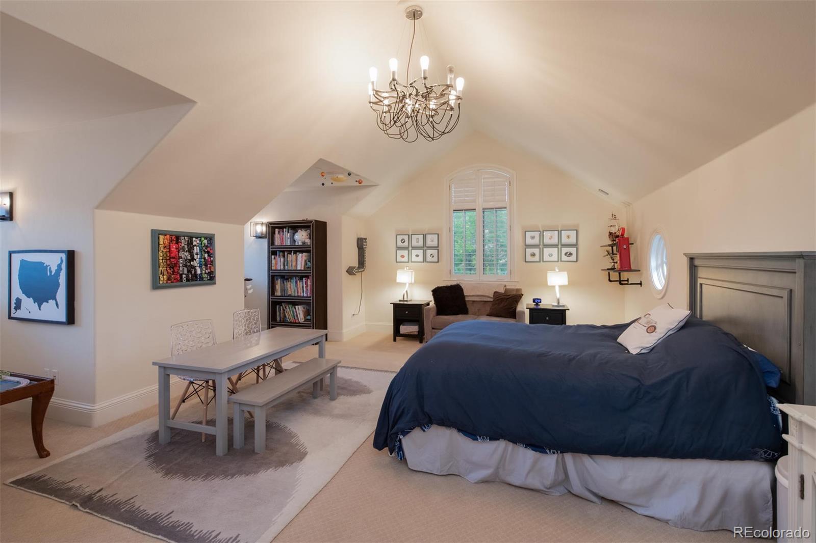 3 Sandy Lake Road Englewood, CO 80113 - Photo 24 of 35 a bedroom with a bed a table and chair