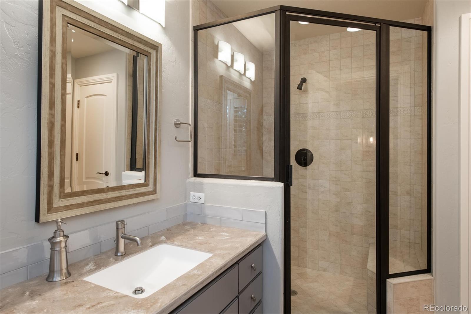 3 Sandy Lake Road Englewood, CO 80113 - Photo 25 of 35 a bathroom with a granite countertop sink and a mirror