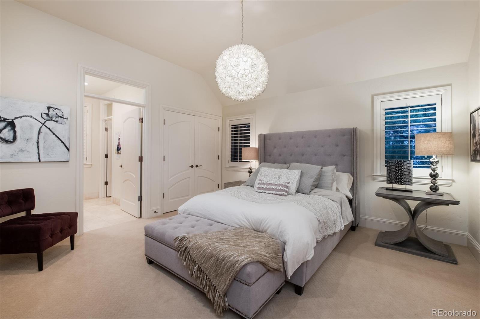 3 Sandy Lake Road Englewood, CO 80113 - Photo 26 of 35 a spacious bedroom with a bed and a chandelier