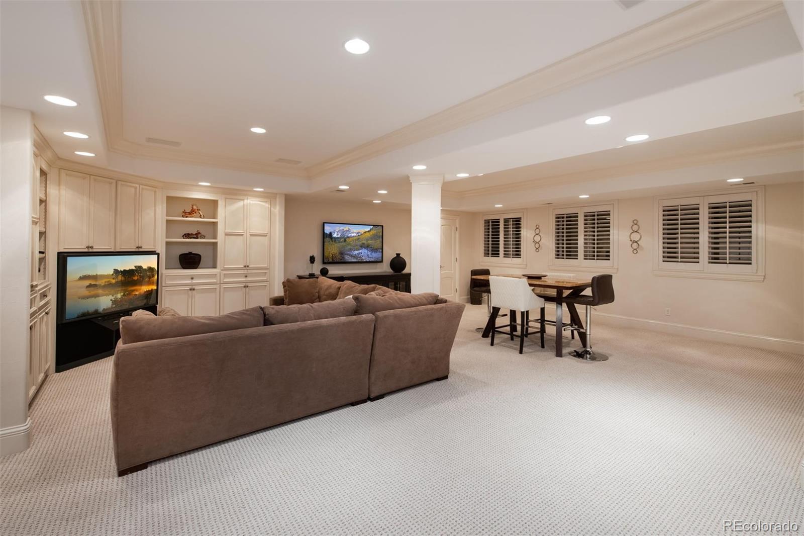 3 Sandy Lake Road Englewood, CO 80113 - Photo 27 of 35 a living room with furniture and a flat screen tv