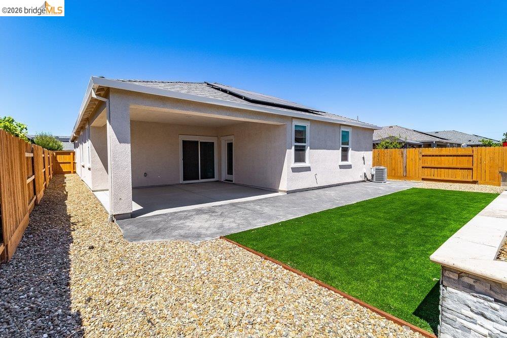 4347 Canada Way Rio Vista, CA 94571 - Photo 32 of 41 Rear exterior featuring a covered patio, artificial turf, gravel landscaping, and a wood privacy fence