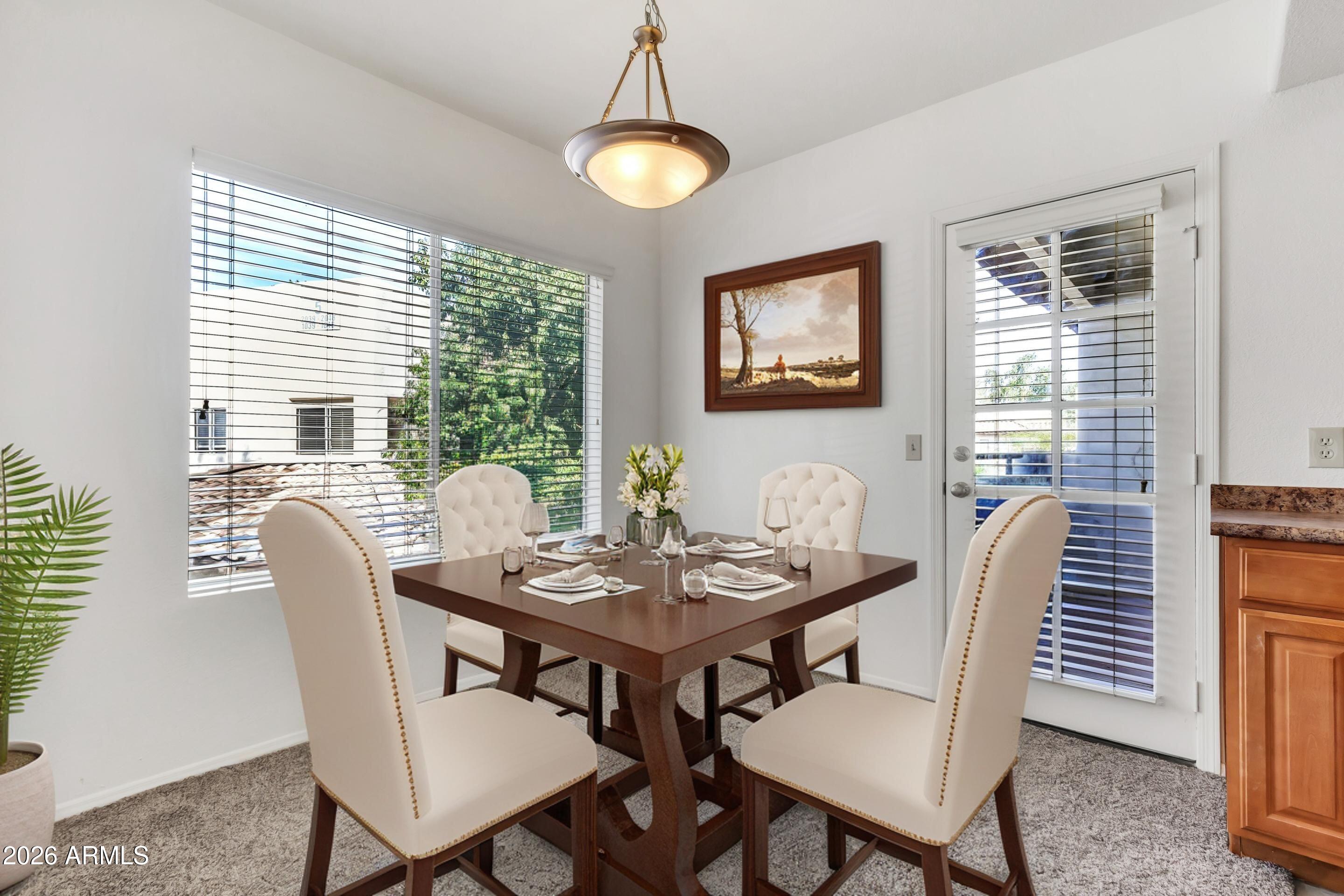 1825 West Ray Road, Unit 2072 Chandler, AZ 85224 - Photo 9 of 47 a view of a dining room with furniture window and outside view