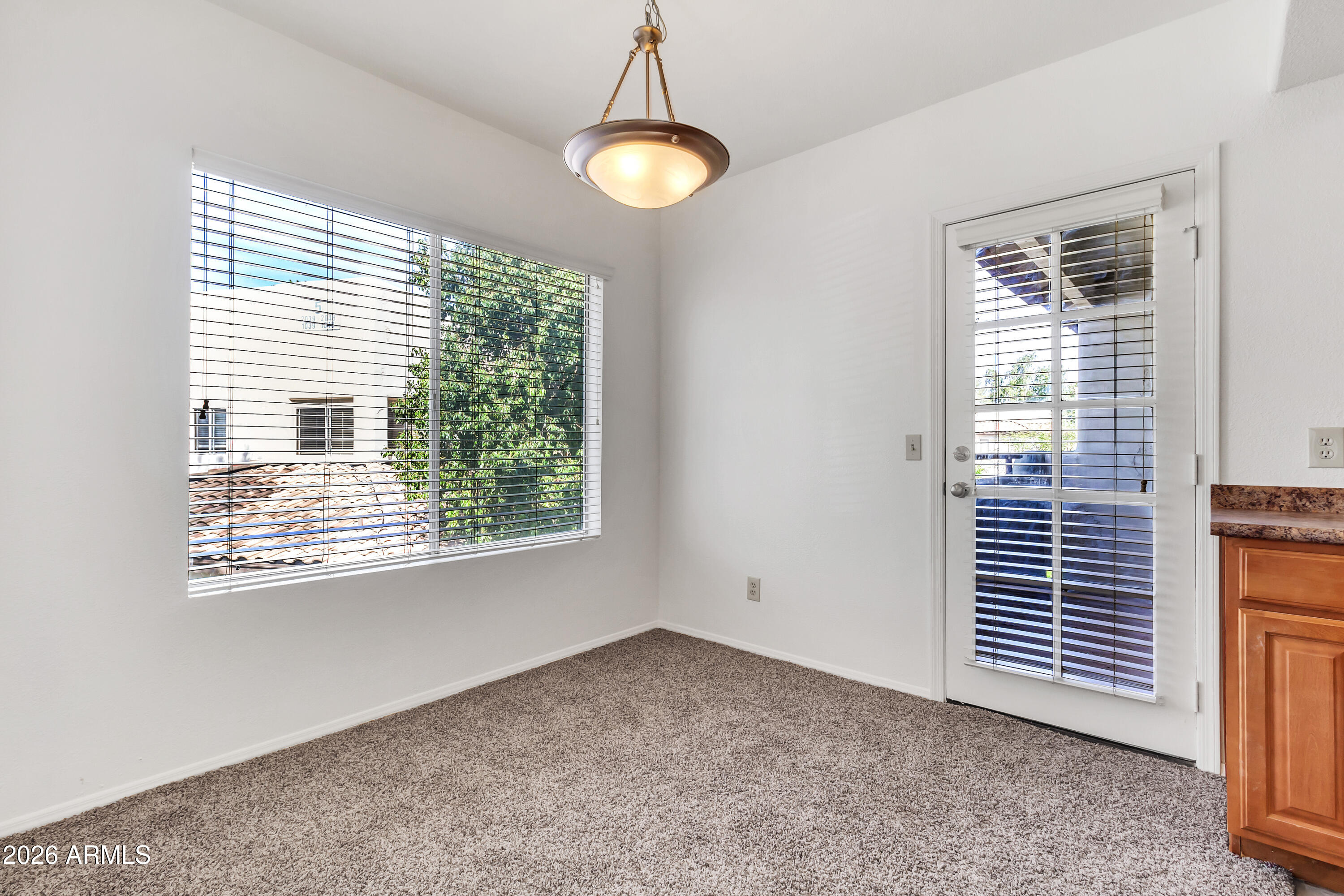 1825 West Ray Road, Unit 2072 Chandler, AZ 85224 - Photo 10 of 47 a view of a livingroom with a window and brick kitchen