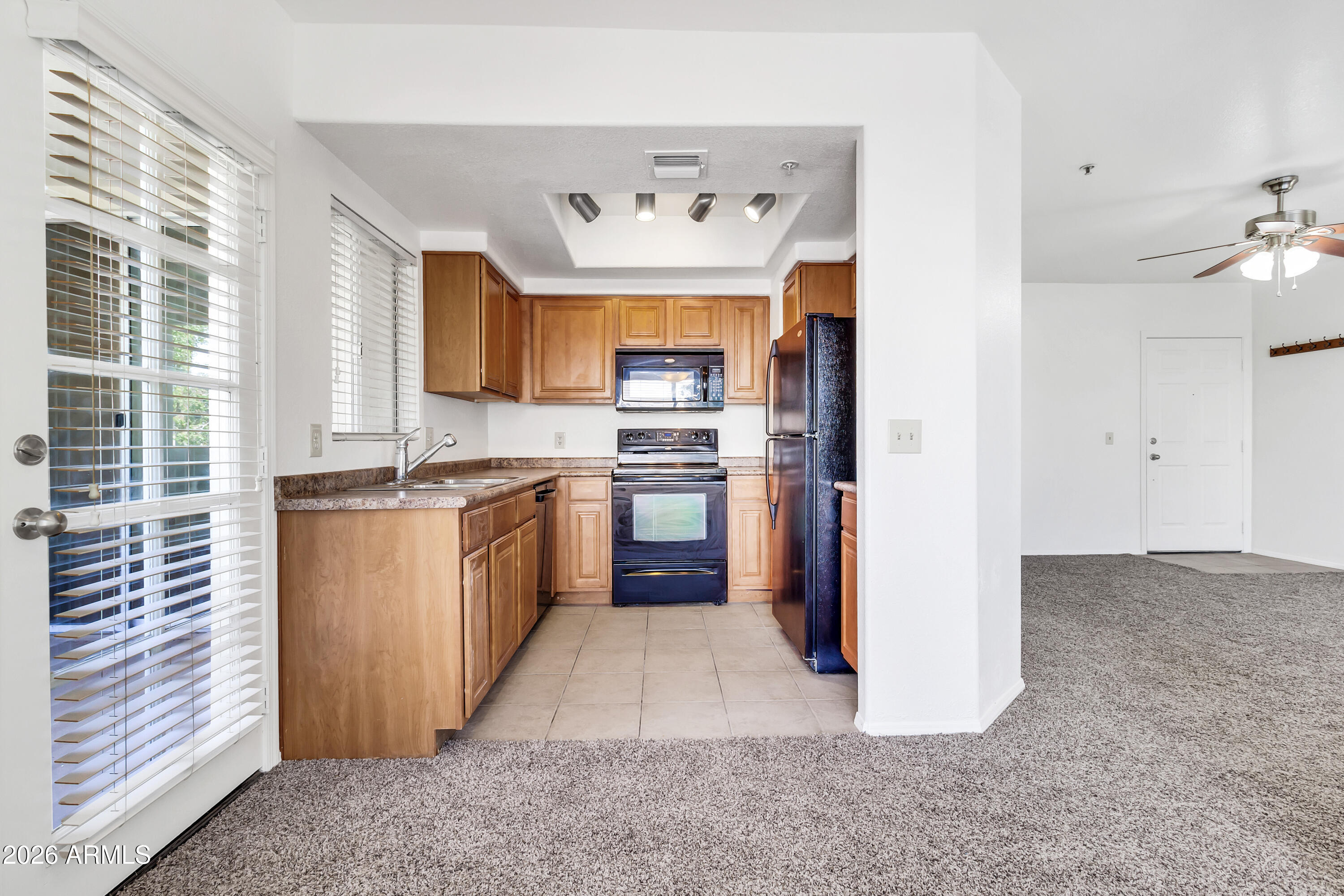 1825 West Ray Road, Unit 2072 Chandler, AZ 85224 - Photo 11 of 47 a kitchen with a refrigerator and a sink