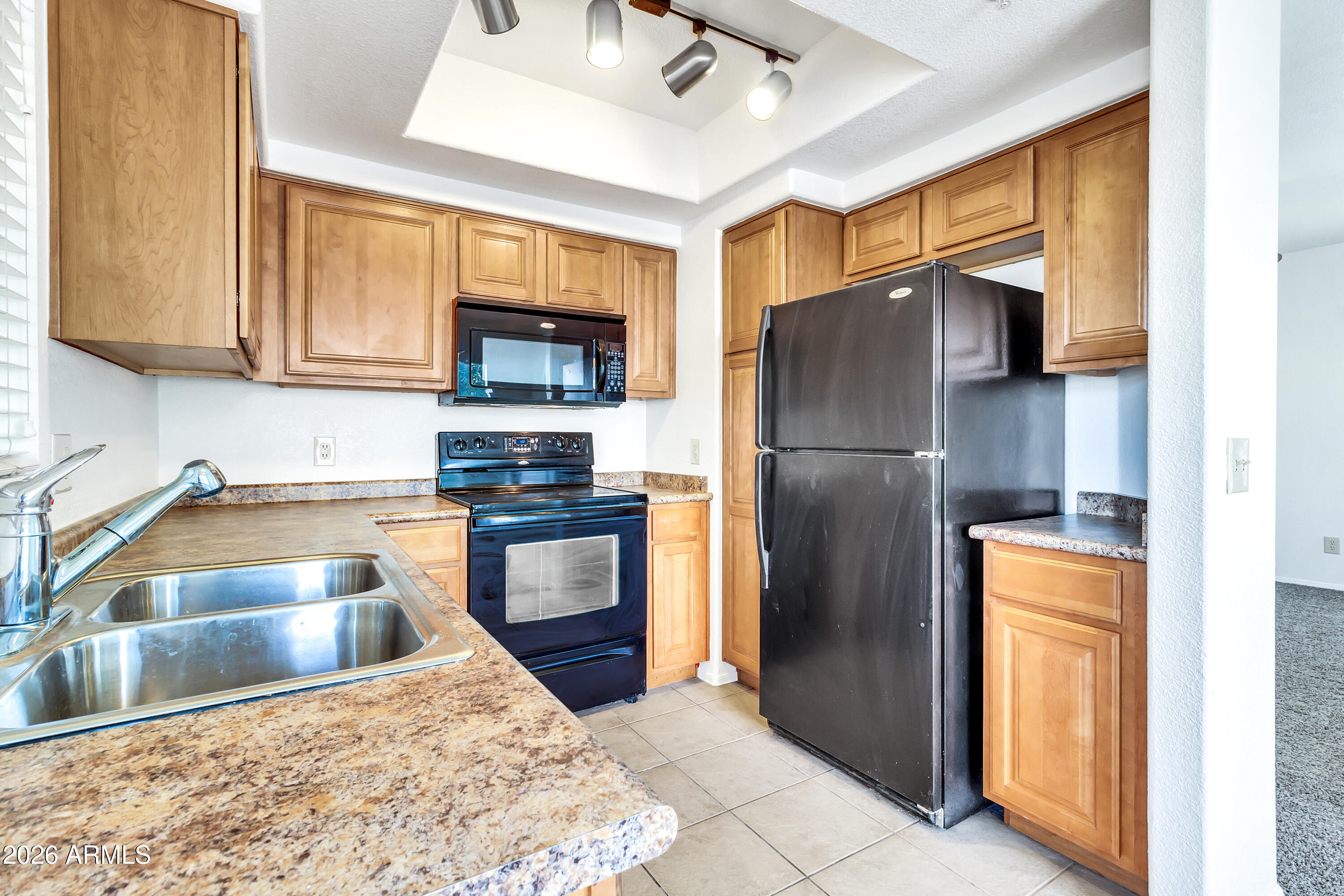 1825 West Ray Road, Unit 2072 Chandler, AZ 85224 - Photo 12 of 47 a kitchen with stainless steel appliances granite countertop a refrigerator a stove and a sink with granite countertops