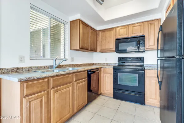 a kitchen with a refrigerator and a sink