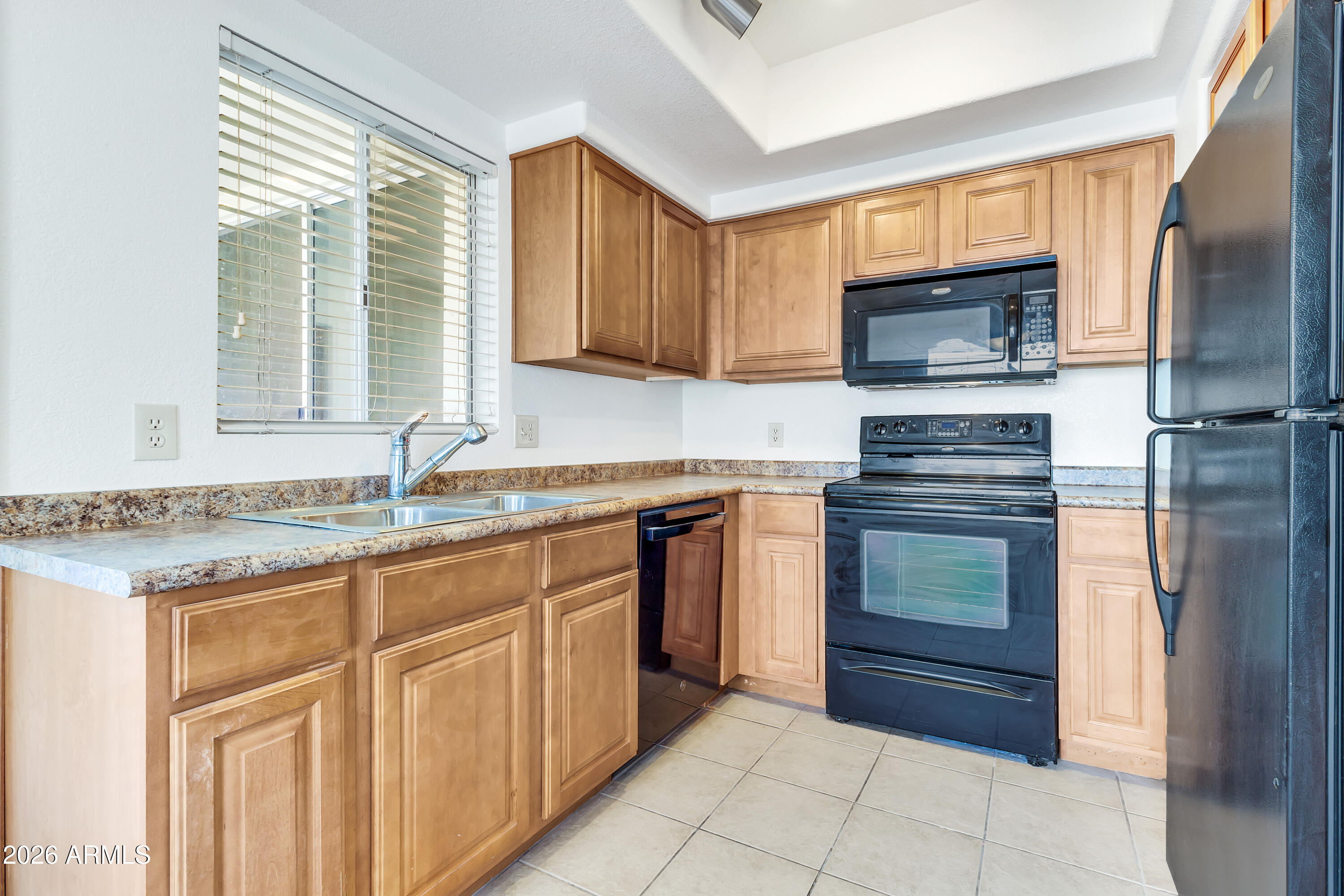 1825 West Ray Road, Unit 2072 Chandler, AZ 85224 - Photo 13 of 47 a kitchen with granite countertop a sink stainless steel appliances and cabinets