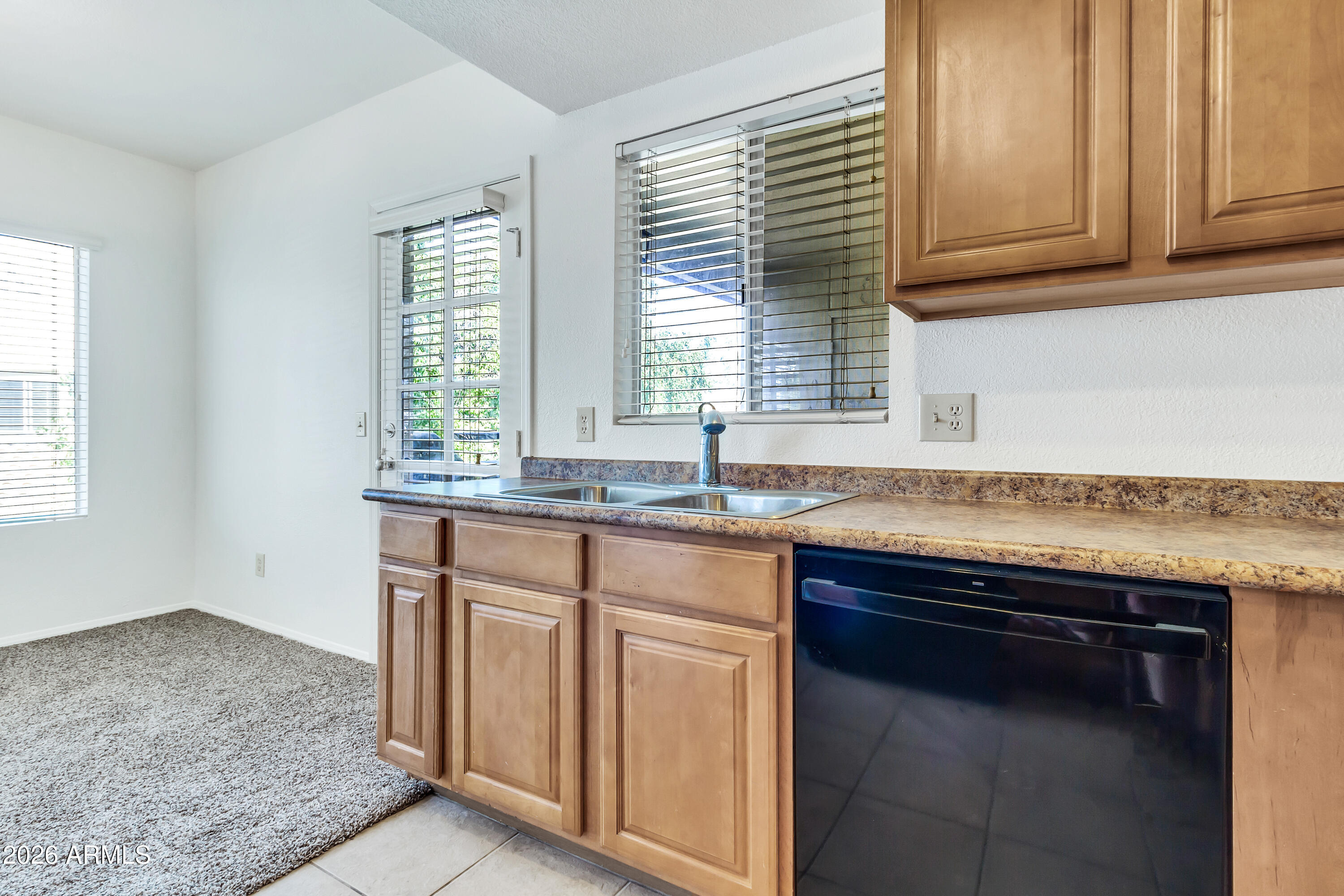 1825 West Ray Road, Unit 2072 Chandler, AZ 85224 - Photo 14 of 47 a kitchen with granite countertop a sink and a stove