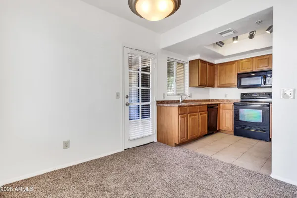 a kitchen with granite countertop a sink stainless steel appliances and cabinets