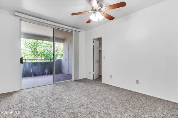 a bedroom with a large bed and a window