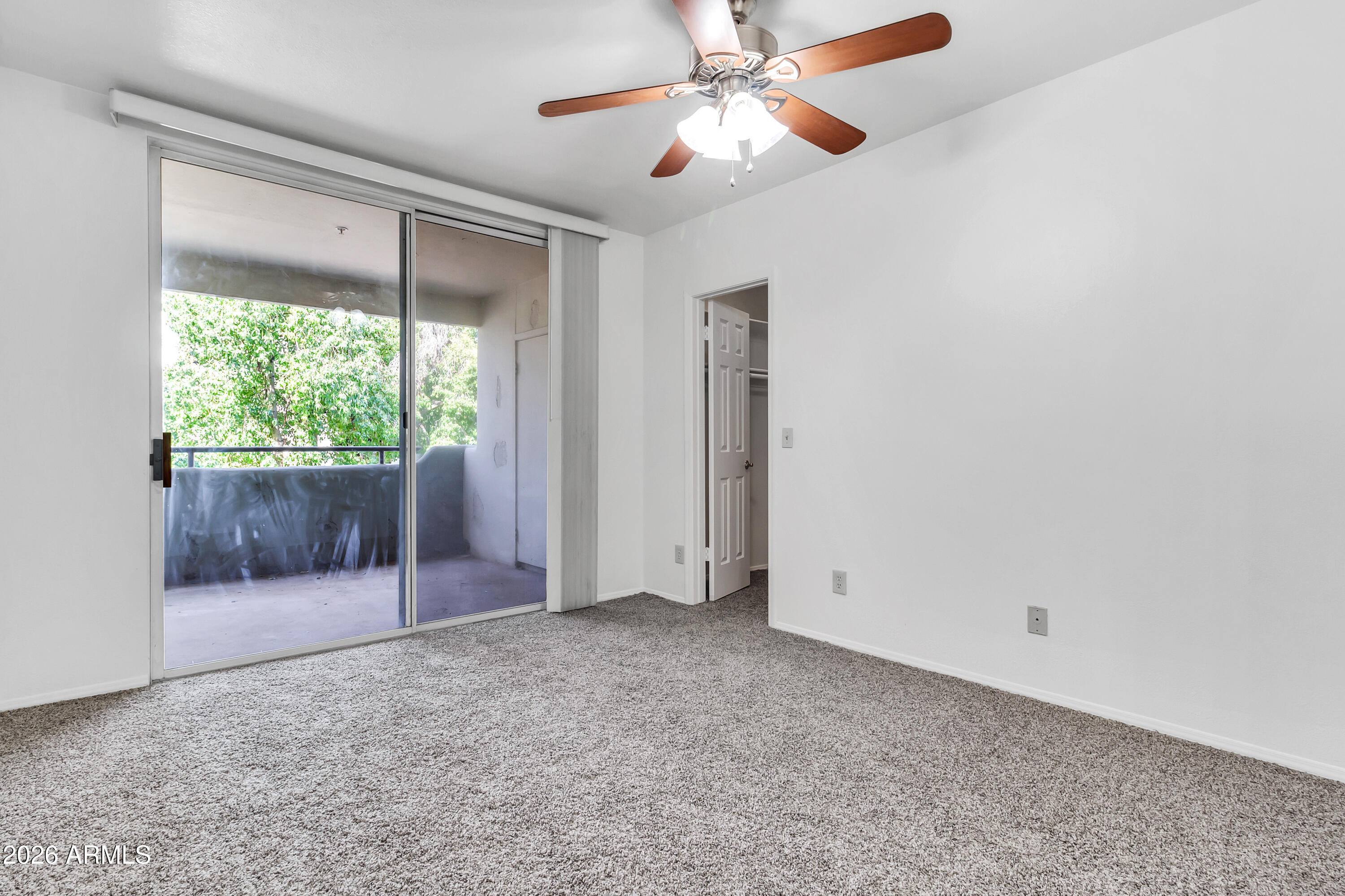 1825 West Ray Road, Unit 2072 Chandler, AZ 85224 - Photo 18 of 47 an empty room with a ceiling fan and a window