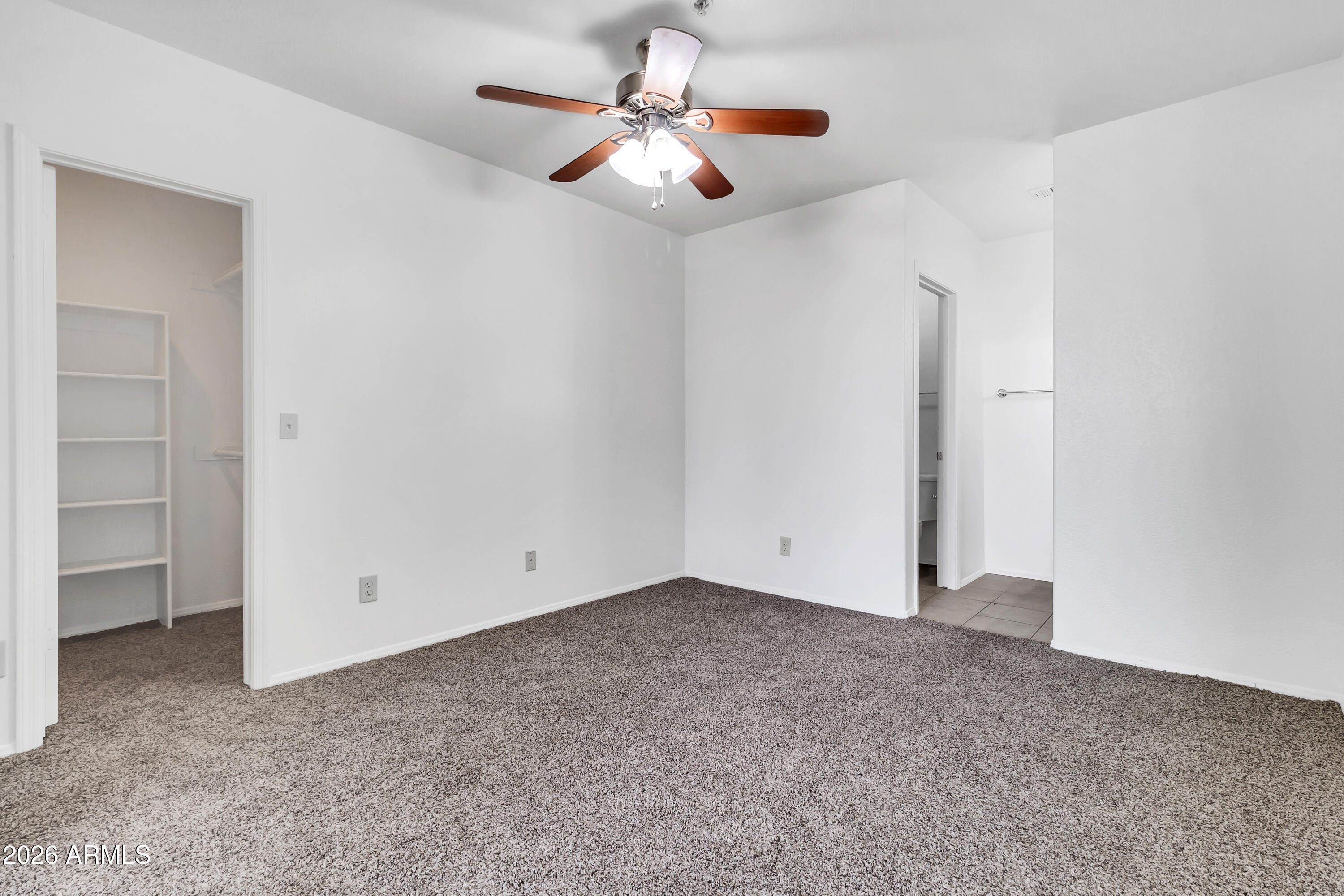1825 West Ray Road, Unit 2072 Chandler, AZ 85224 - Photo 19 of 47 an empty room with closet and windows