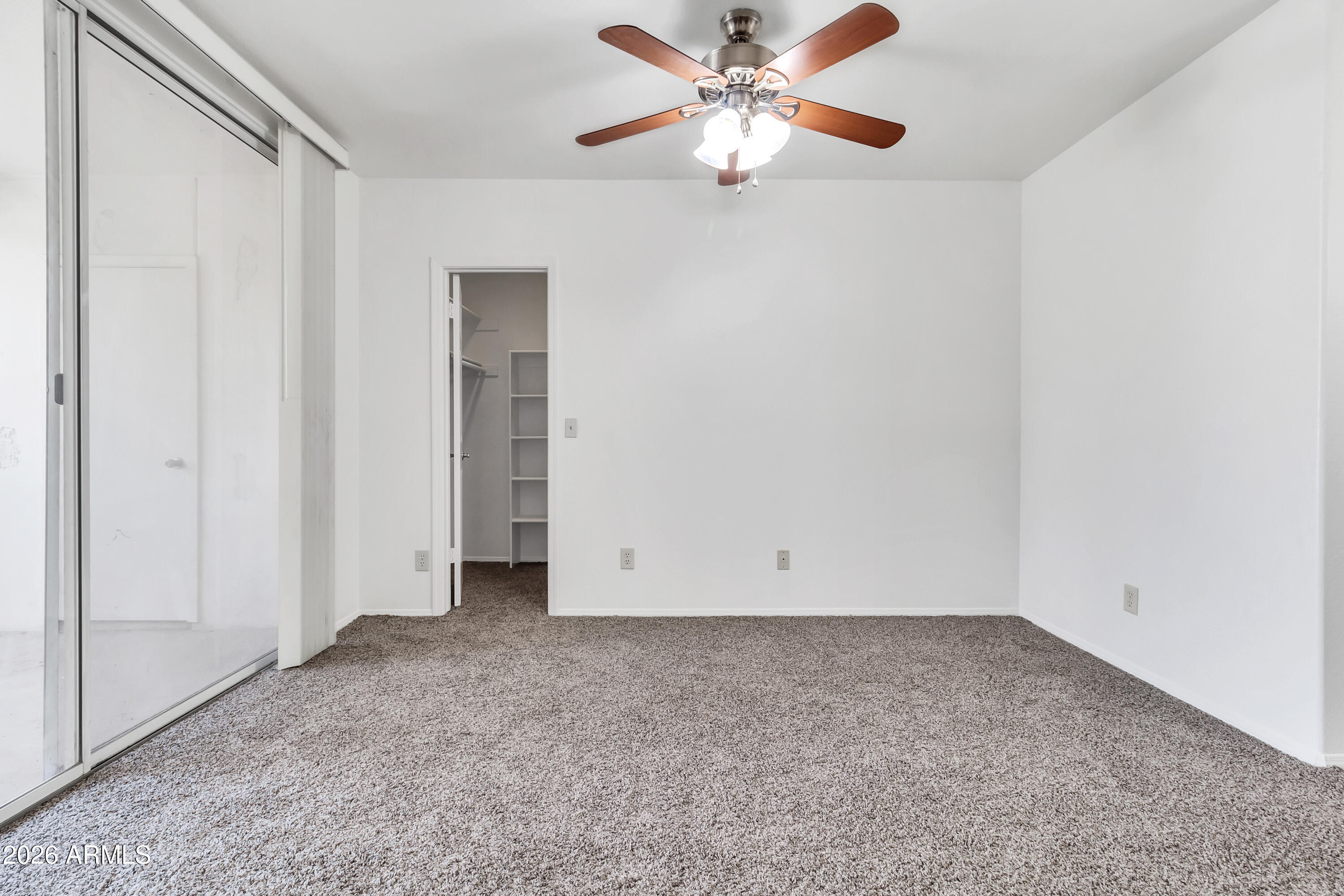 1825 West Ray Road, Unit 2072 Chandler, AZ 85224 - Photo 20 of 47 an empty room with chandelier fan
