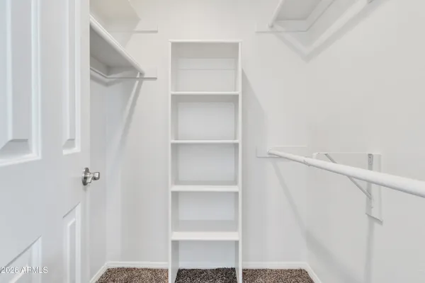 an empty room with chandelier fan
