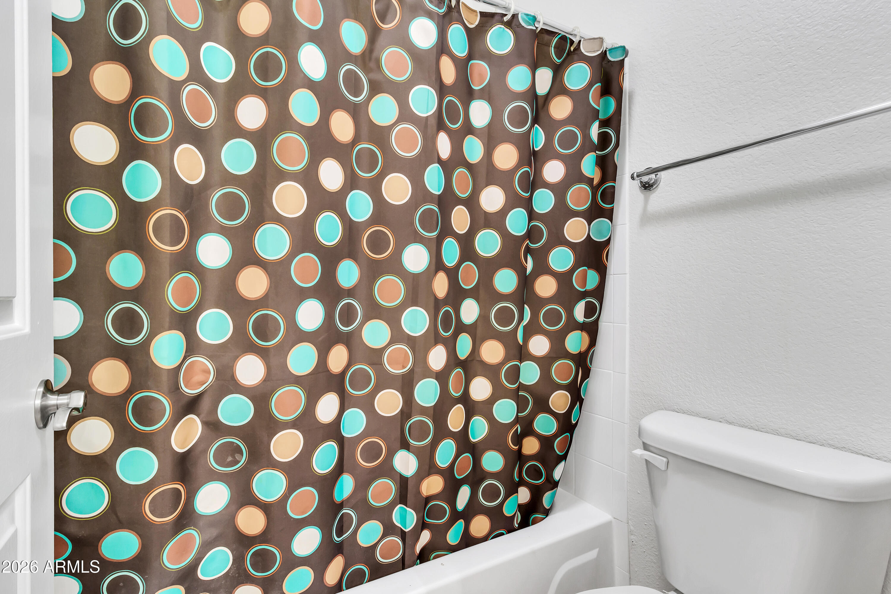 1825 West Ray Road, Unit 2072 Chandler, AZ 85224 - Photo 23 of 47 a white toilet sitting next to a shower curtain