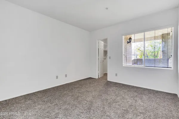 a bedroom with a bed and a potted plant