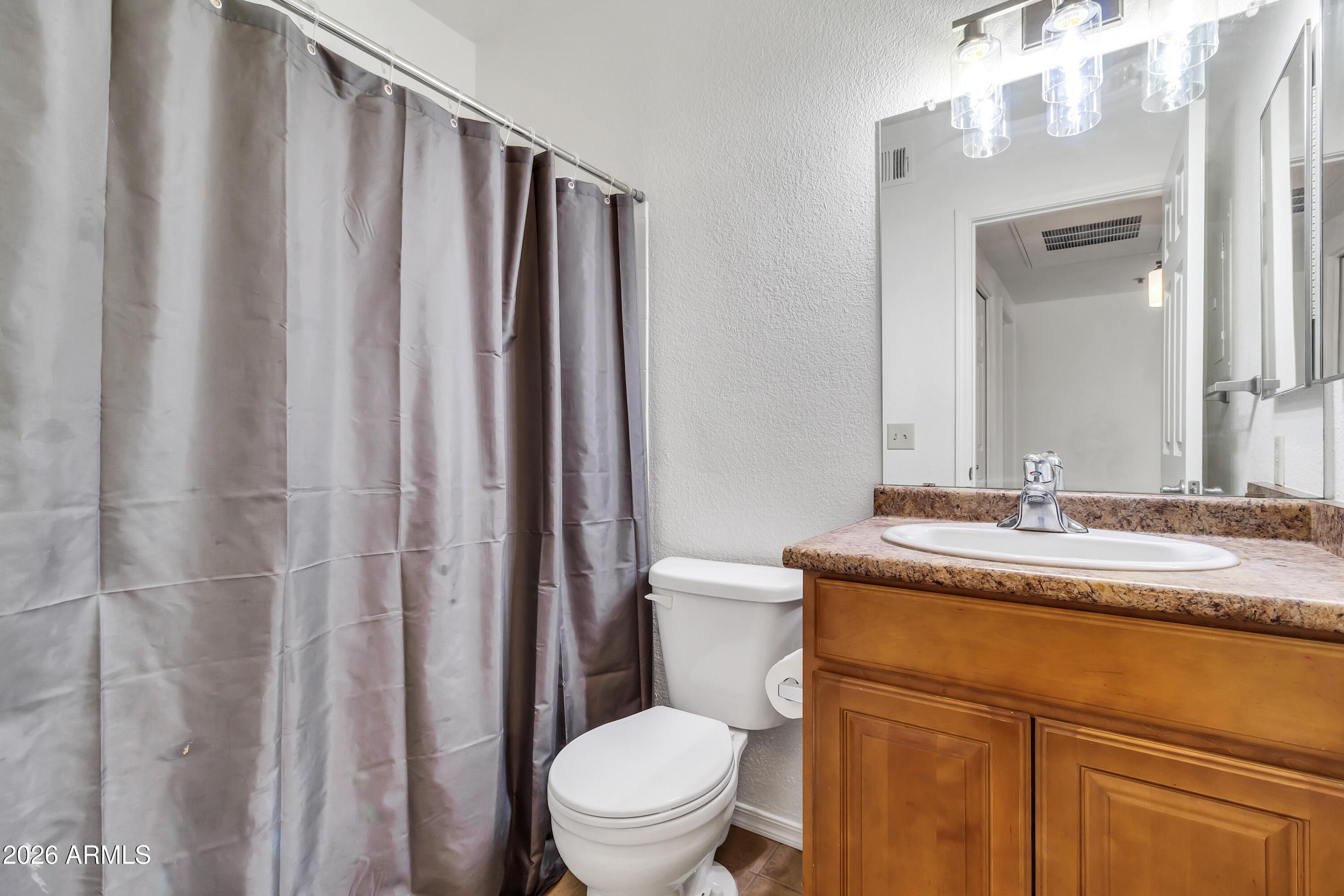 1825 West Ray Road, Unit 2072 Chandler, AZ 85224 - Photo 30 of 47 a bathroom with a granite countertop sink toilet and mirror