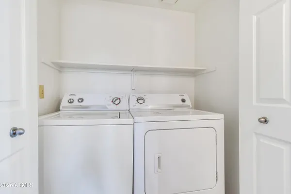 a bathroom with a granite countertop sink toilet and mirror