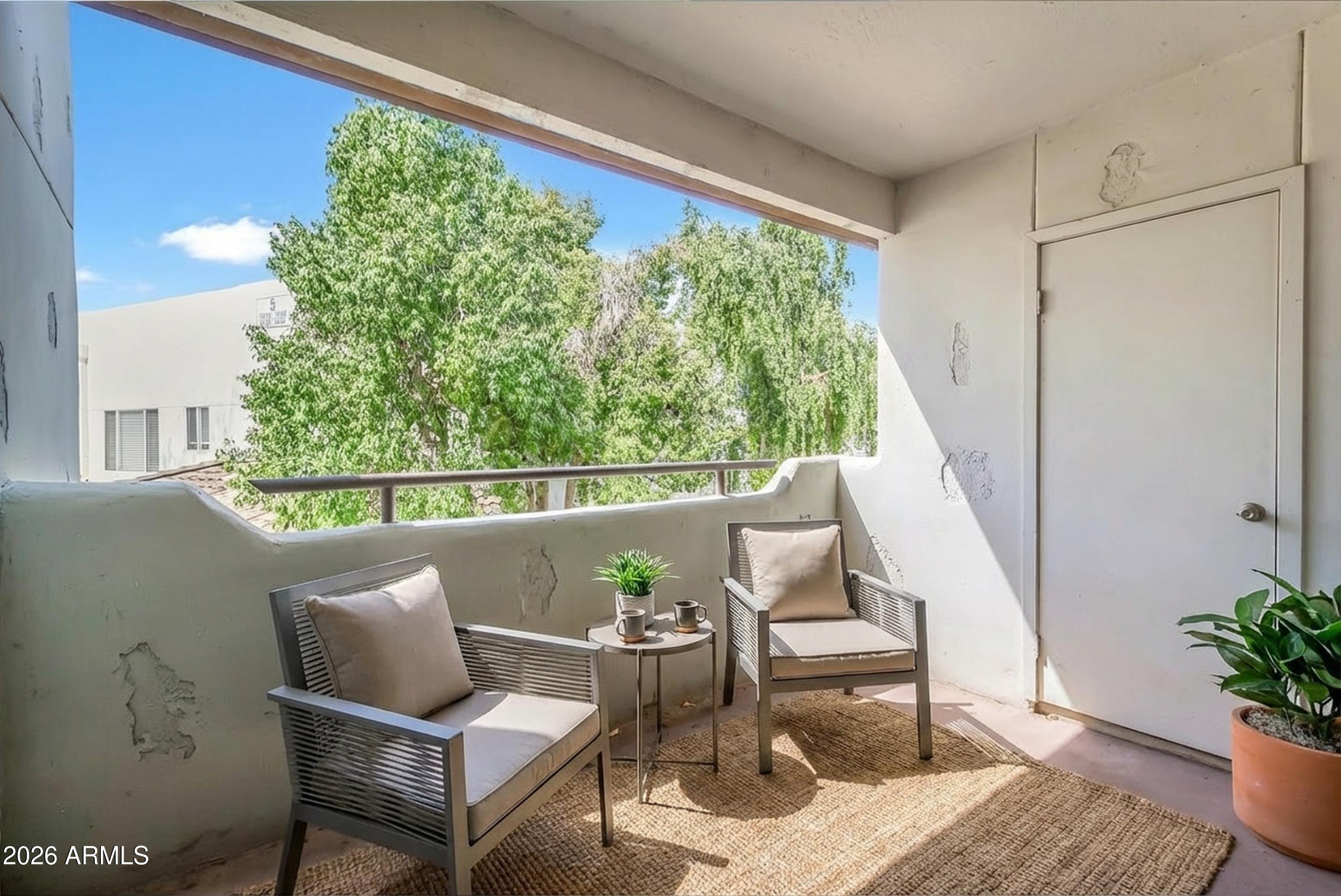 1825 West Ray Road, Unit 2072 Chandler, AZ 85224 - Photo 32 of 47 a outdoor living room with furniture and a potted plant