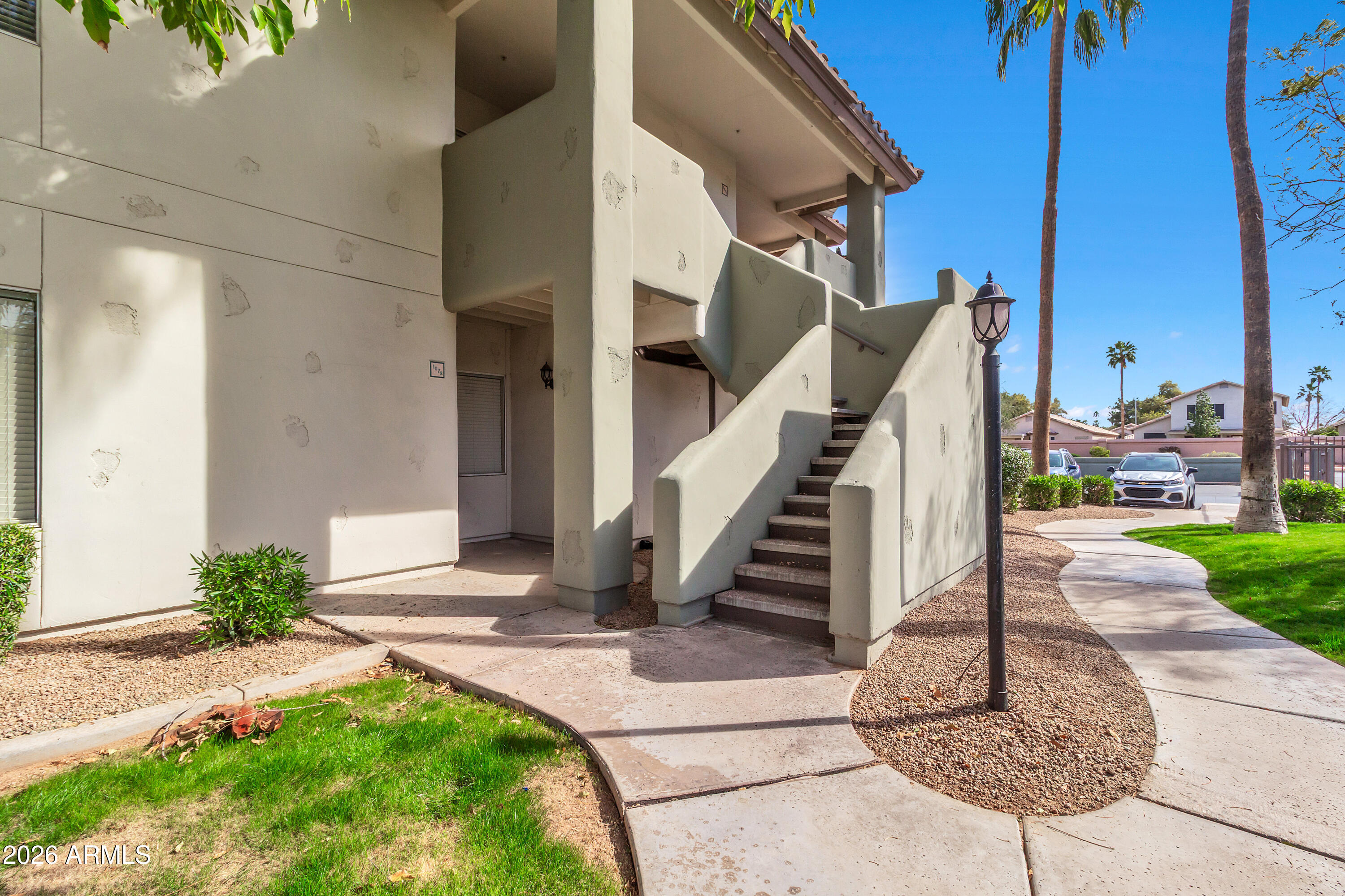 1825 West Ray Road, Unit 2072 Chandler, AZ 85224 - Photo 3 of 47 a view of stairs and a yard