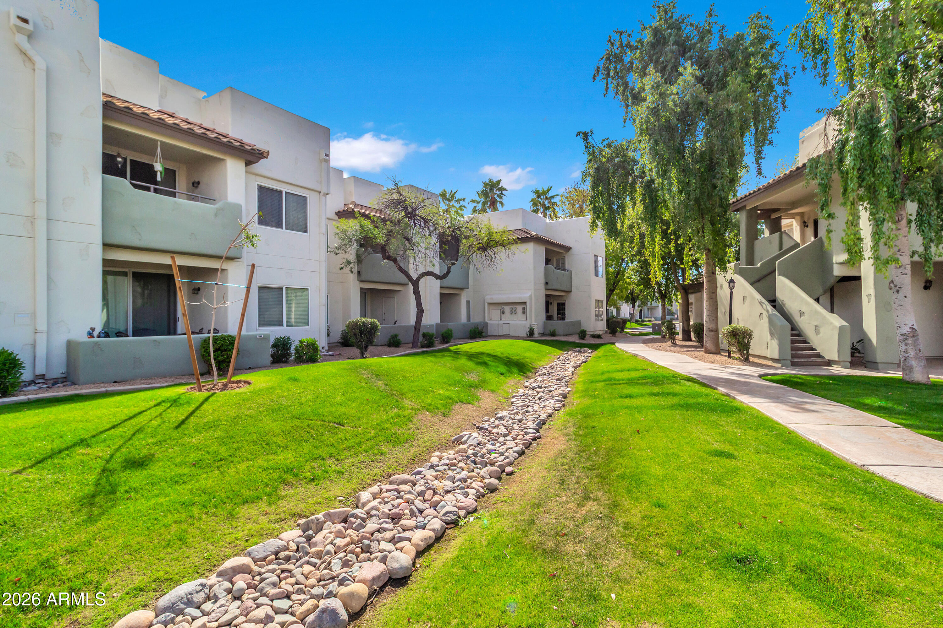 1825 West Ray Road, Unit 2072 Chandler, AZ 85224 - Photo 40 of 47 a view of a house with a yard and pathway