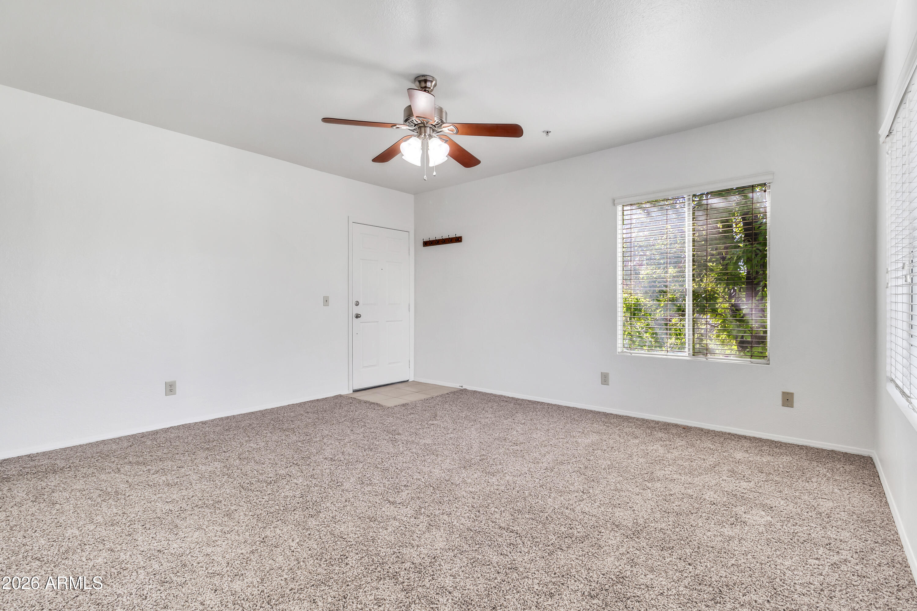 1825 West Ray Road, Unit 2072 Chandler, AZ 85224 - Photo 4 of 47 an empty room with windows and fan