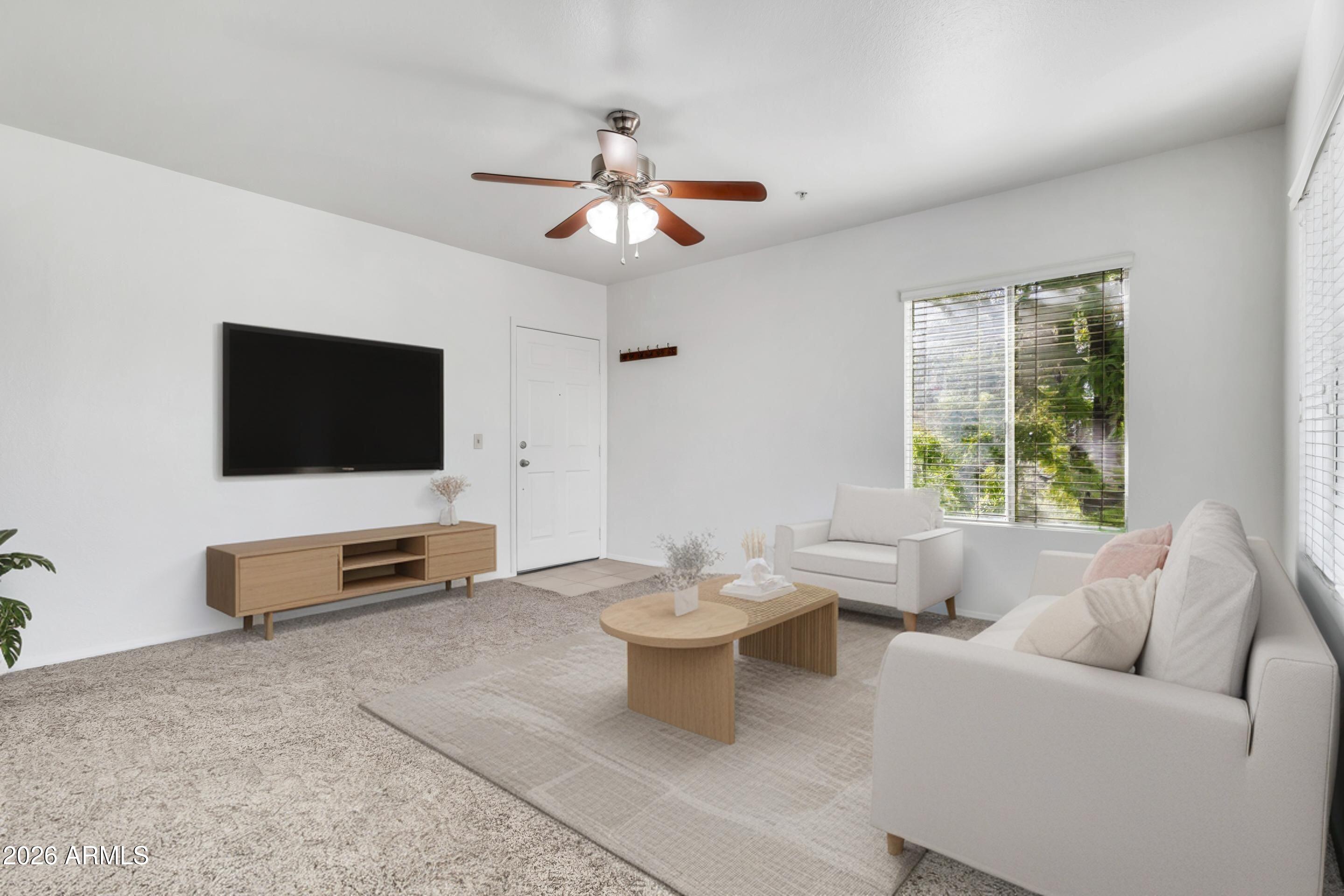 1825 West Ray Road, Unit 2072 Chandler, AZ 85224 - Photo 5 of 47 a living room with furniture a flat screen tv and a window