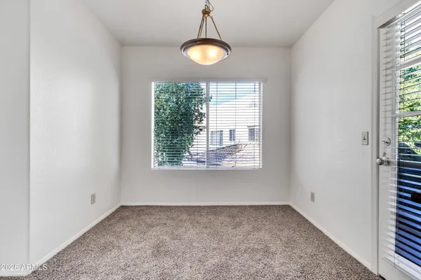 an empty room with closet and fan