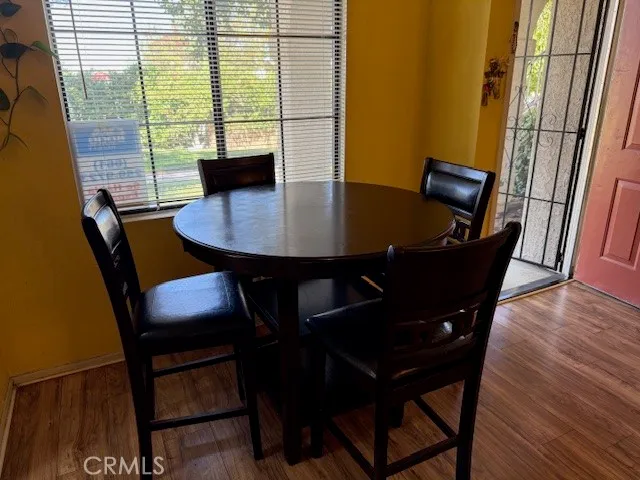 a view of a dining room with furniture and wooden floor