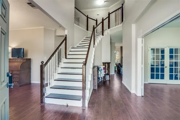 a view of entryway and hall with wooden floor