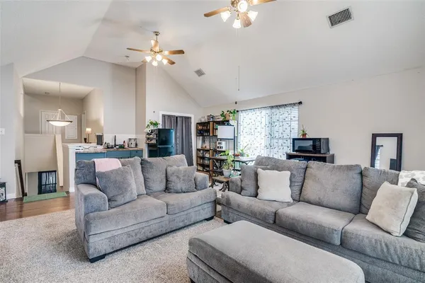 a living room with furniture and a chandelier