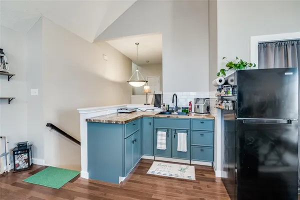 a kitchen with kitchen island a sink stove and refrigerator