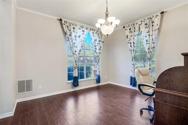 a view of a dining room with furniture wooden floor and chandelier