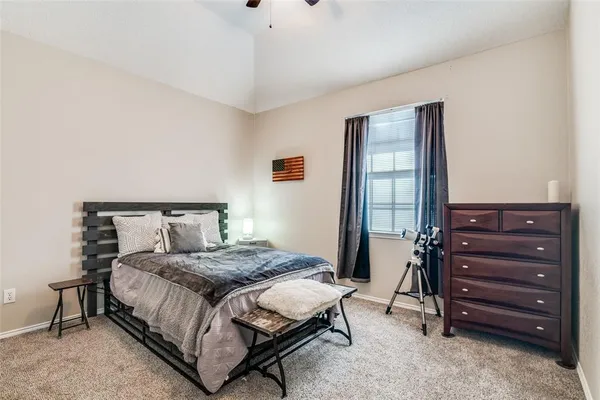 a bedroom with a bed and a dresser