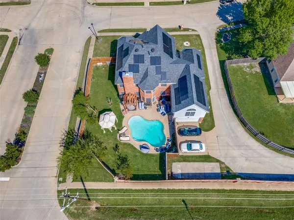 an aerial view of a house with a swimming pool