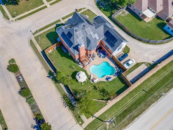 an aerial view of a house a yard and outdoor seating