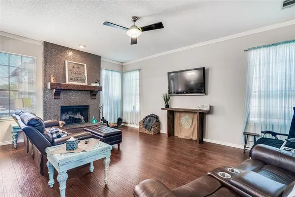 a living room with furniture a fireplace and a flat screen tv
