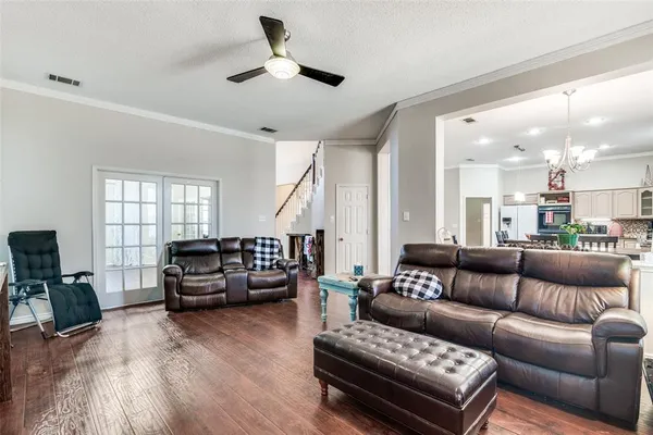 a living room with furniture and wooden floor