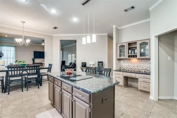 a kitchen with granite countertop cabinets a dining table and chairs
