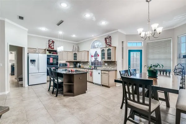 a view of a dining room with furniture and a chandelier