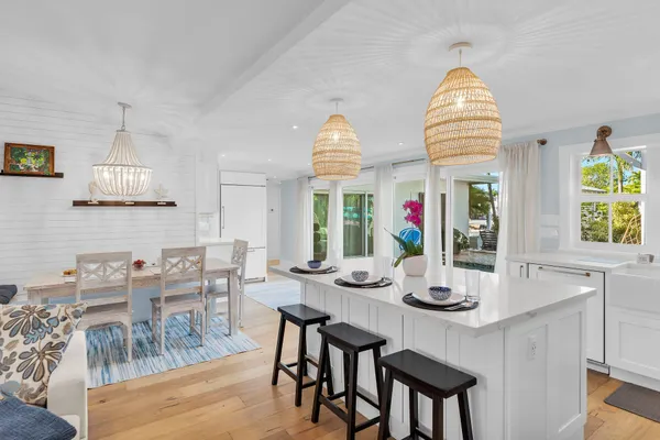 a view of a dining room with furniture a chandelier and wooden floor