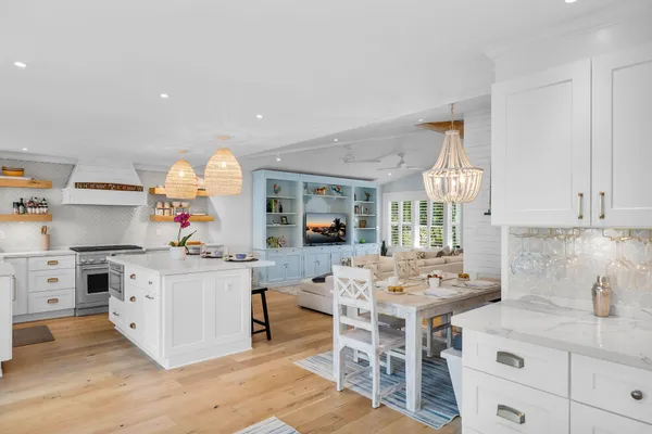 a kitchen with granite countertop a sink stove and cabinets