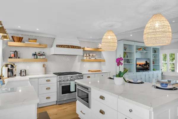 a kitchen with a white cabinets and window