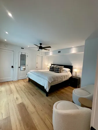 a bedroom with a bed and a large window