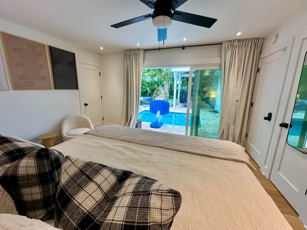 a spacious bedroom with a bed and a mirror