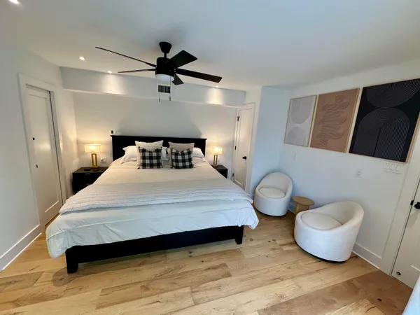 a bedroom with a bed and a large window