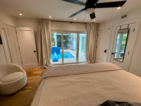 a bedroom with a large bed and a window