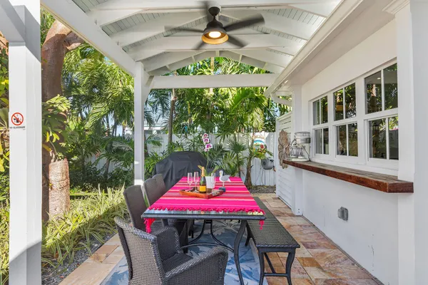 a view of a patio with couches table and chairs and potted plants