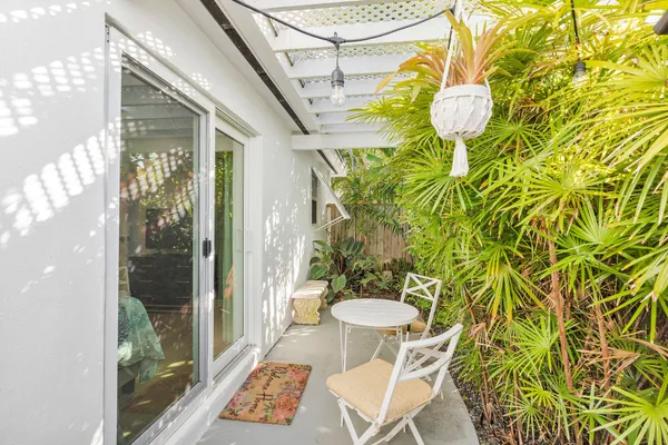 a view of a house with backyard sitting area and porch