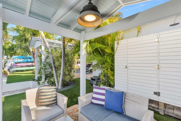 an aerial view of a house with swimming pool and lake view